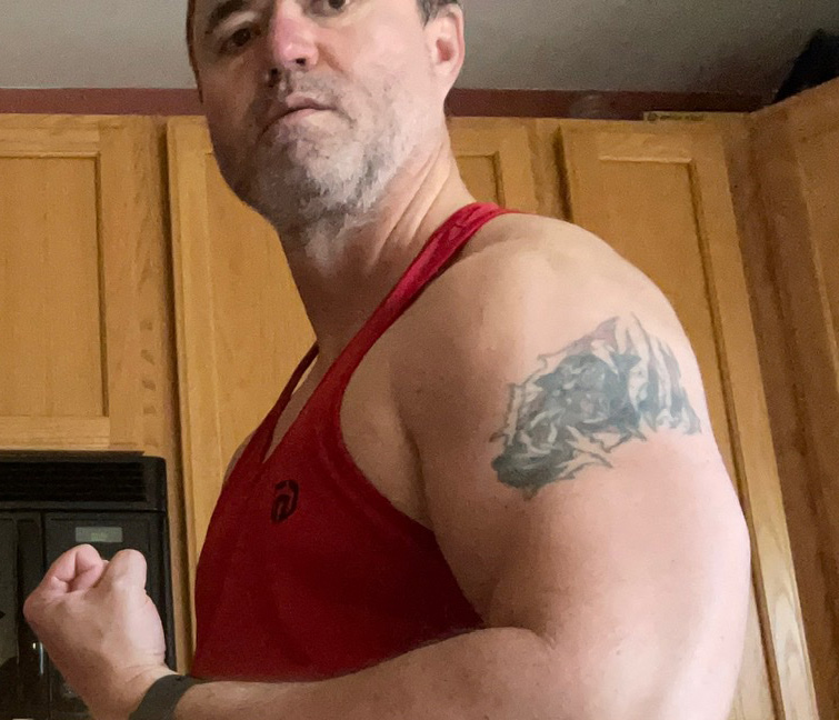 Damon Leach showing off biceps in kitchen