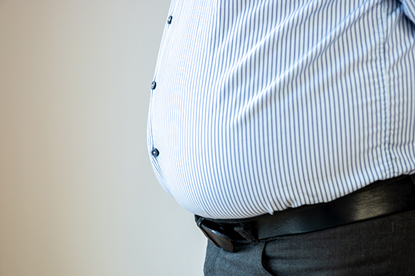 The belly of a fat man in business attire