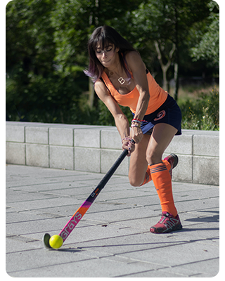 A woman playing street hockey