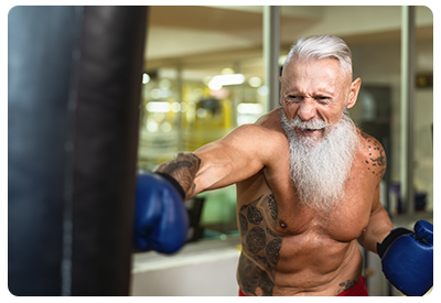 An older male boxing in the gym