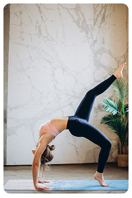 A woman bent over backward doing yoga