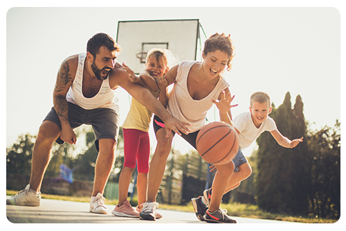 A family of four playing basketball