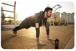 A man doing push-ups in the park