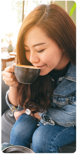 A woman savoring a cup of coffee