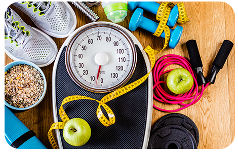 A scale, tape measure, weights and other fitness equipment