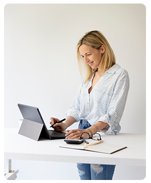 Woman working while standing at desk