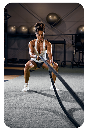 A woman using battle ropes