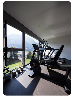 Various workout equipment in room with a large window